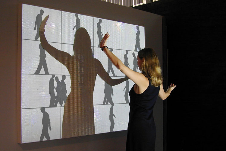 This undated photo provided by the Milwaukee Art Museum, shows Scott Snibbe's "Deep Walls" in Milwaukee. Deep Wall is a grid that consists of 16 silhouettes from shadows of the last 16 people who interacted with it. It is part of "Act/React: Interactive Installation Art." The exhibit makes its world premiere at the Milwaukee Art Museum Saturday, Oct. 4, 2008. It runs through Jan. 11. (AP Photo/Courtesy of Scott Snibbe, Milwaukee Art Museum) ** NO SALES**
